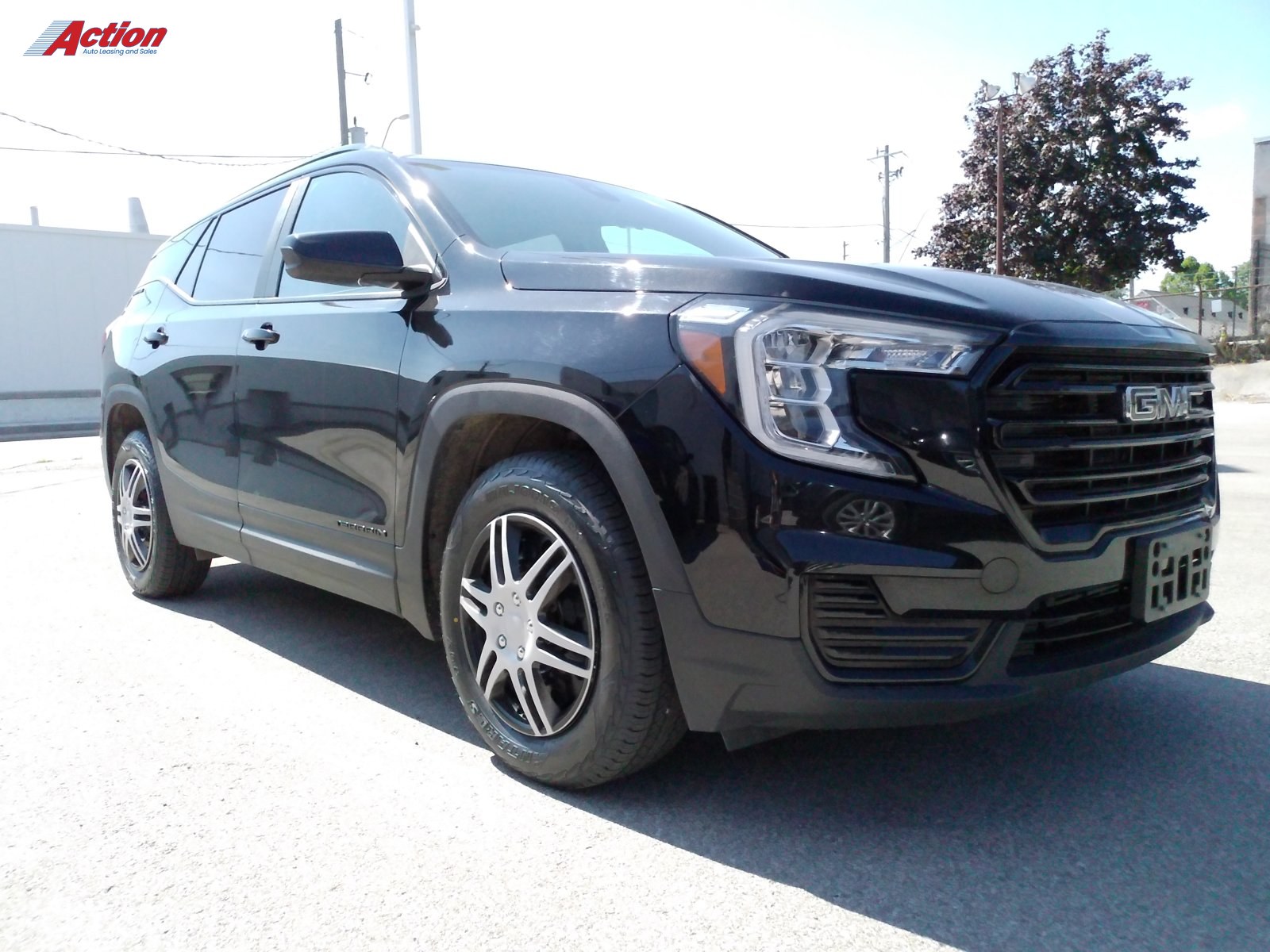 Black GMC SUV parked outdoors with a clear view of the front and side.