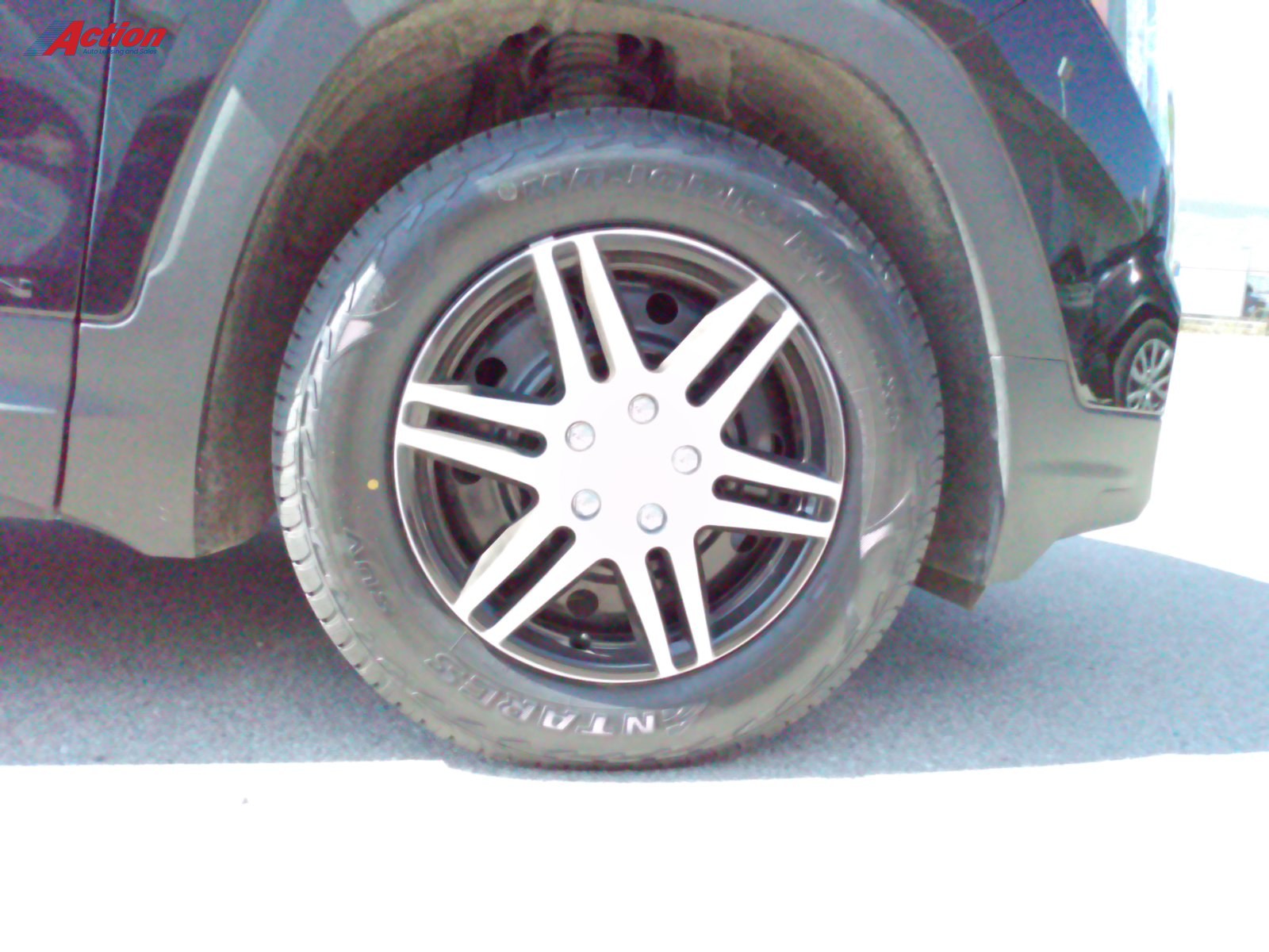 Close-up shot of a stylish black alloy wheel on a vehicle.