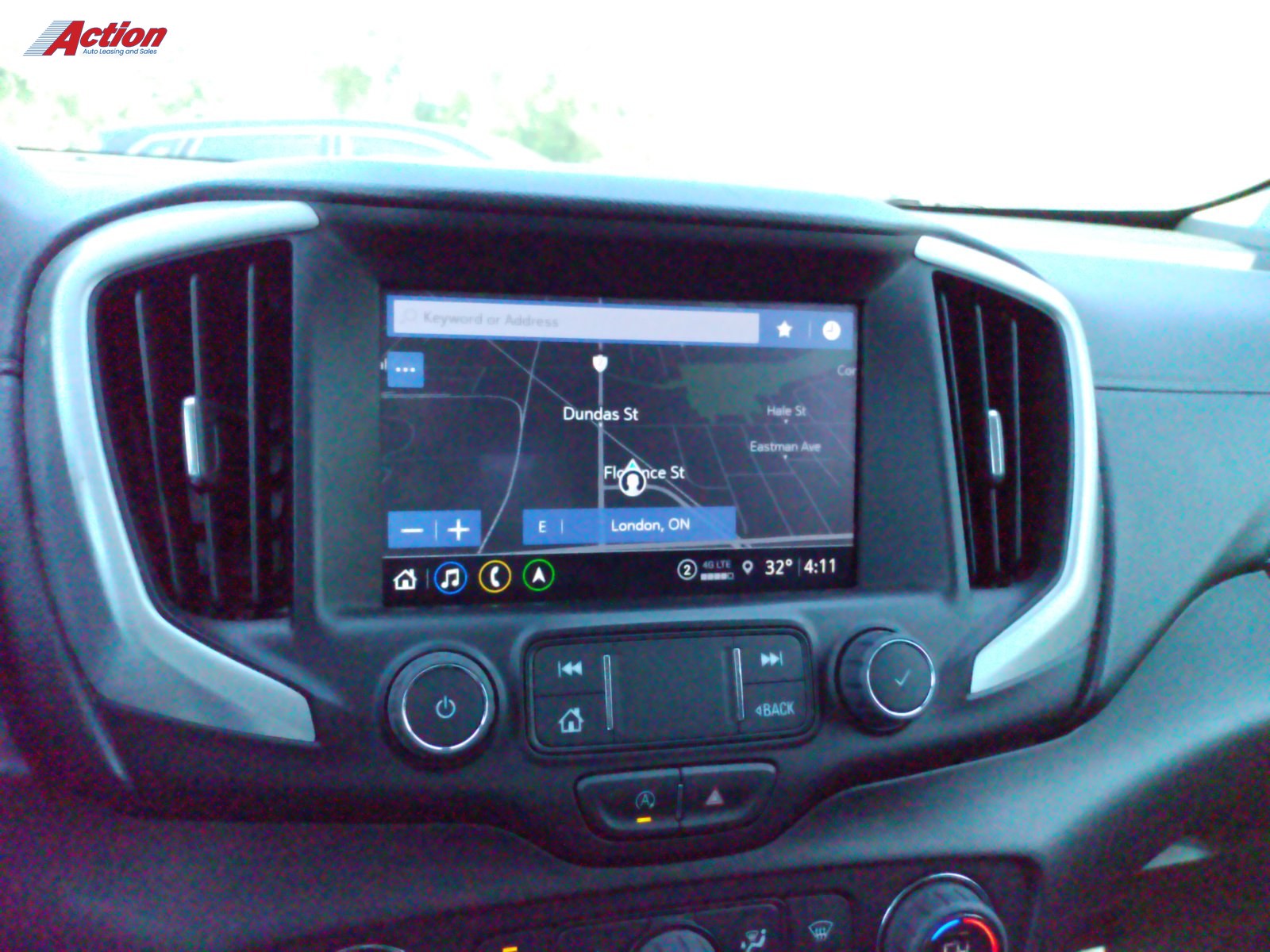 Dashboard view showing navigation screen with map and controls in a vehicle interior.