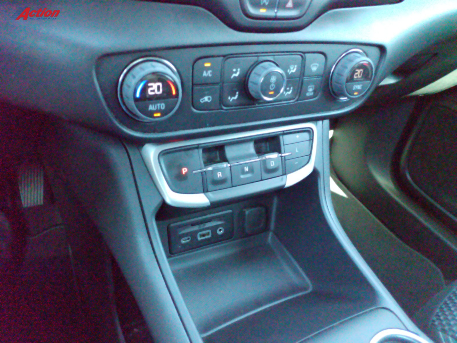 Close-up view of the vehicle's center console featuring climate controls and gear shift.