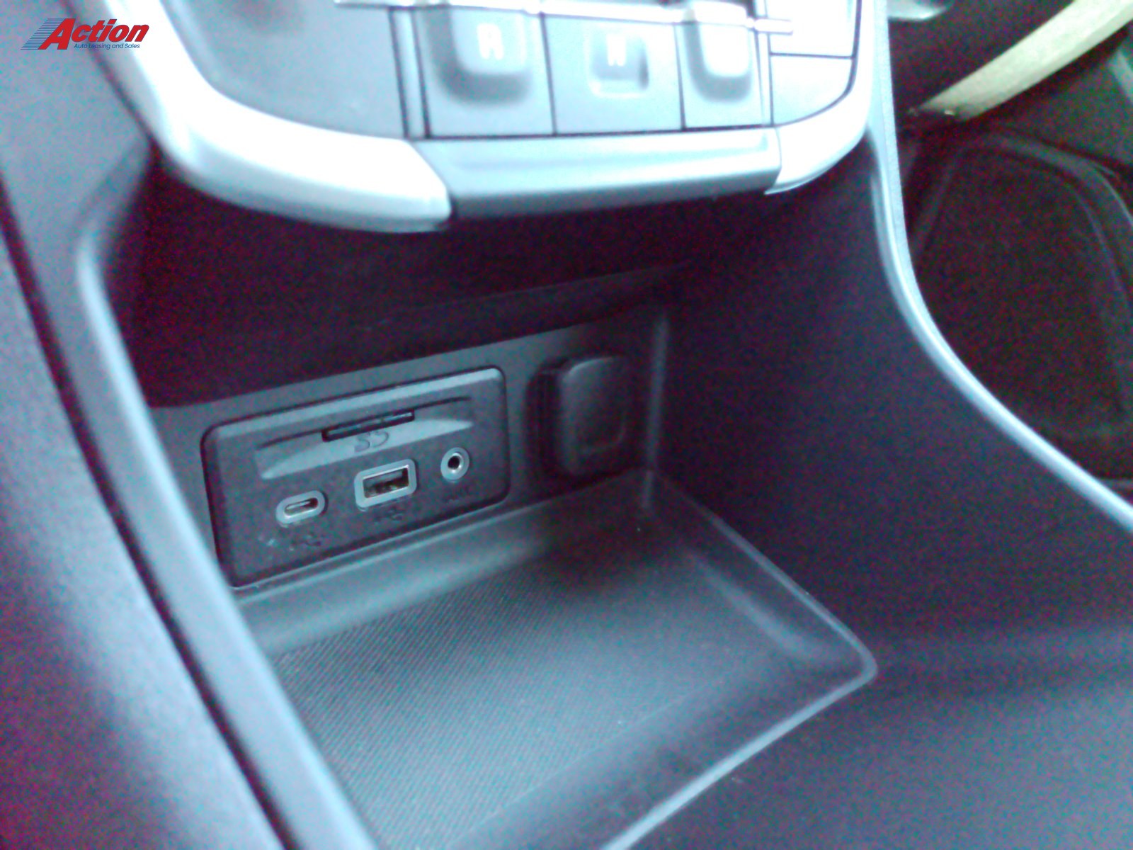 Close-up view of the vehicle's interior console showing USB and auxiliary ports.