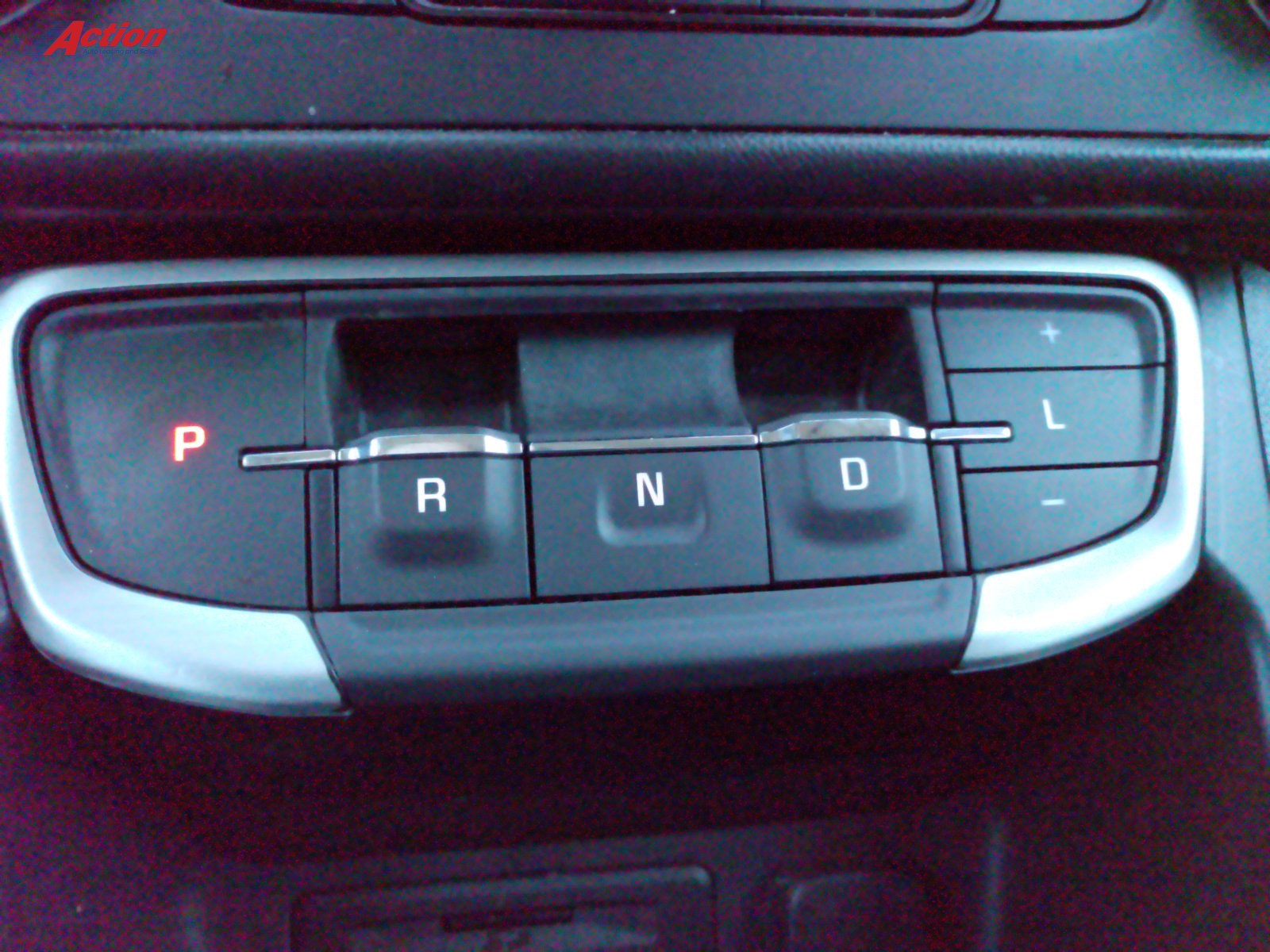 Close-up of a vehicle's gear shift panel showing P, R, N, D, and L options.
